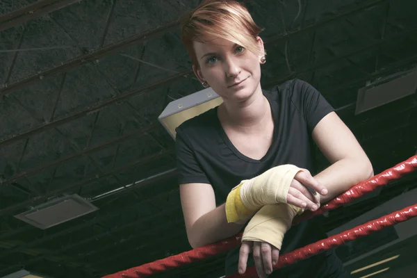 Fitness woman doing punching exercises in training place — Stock Photo, Image