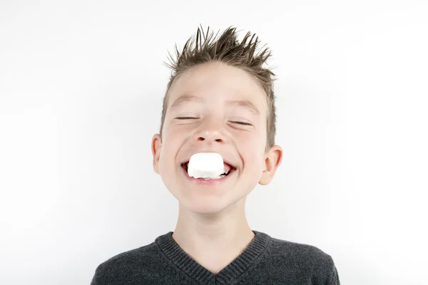 Portrait of cute joyful boy with a marshmallow — Stock Photo, Image