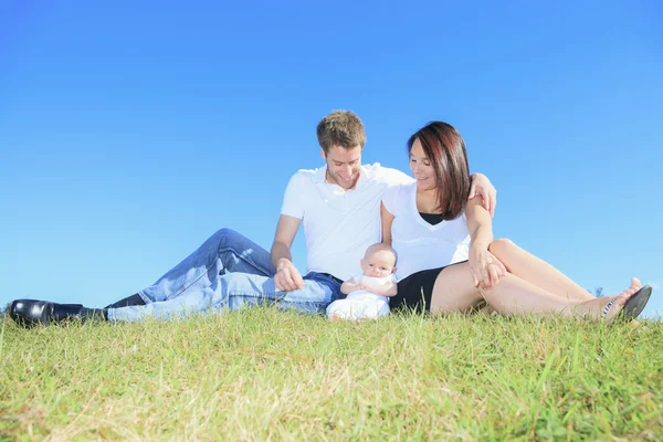 A Happy young family with little baby boy outdoors — Stock Photo, Image