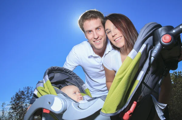 A Happy young family with little baby boy outdoors — Stock Photo, Image