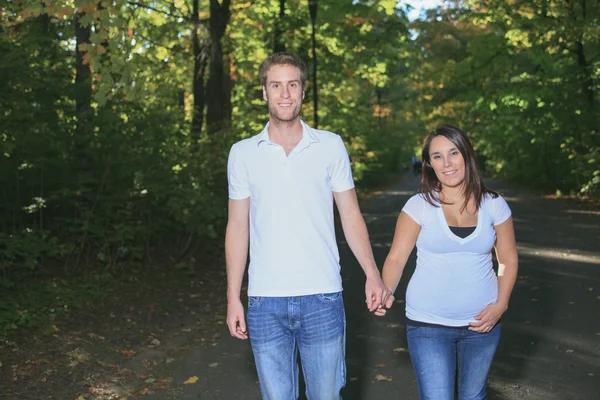 Casal feliz de dois com árvores no fundo sorrindo passeio — Fotografia de Stock