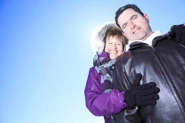 A winter portrait of happy seniors couple hugging. — Stock Photo, Image