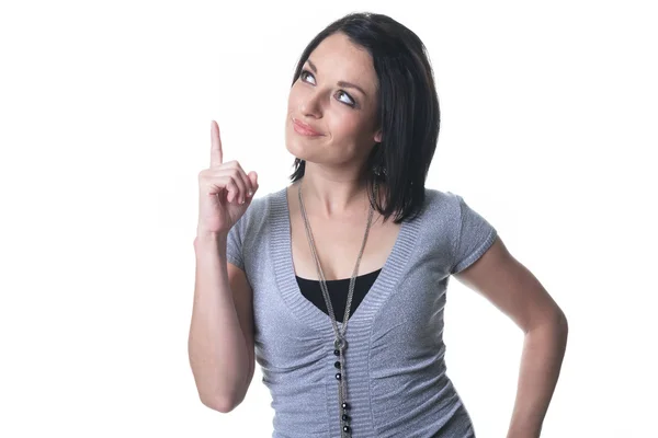 As adult woman pointing in studio white background — Stock Photo, Image