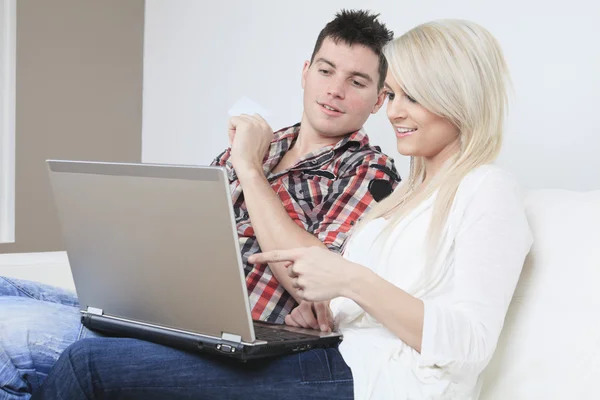 Een paar op Bank met laptop die willen kopen iets op de In — Stockfoto