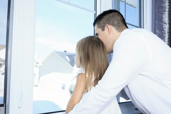 A Young happy father with is daughter close to a window — Stock Photo, Image