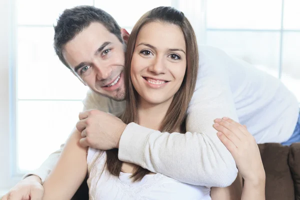 An happy couple at home relaxing in sofa — Stock Photo, Image