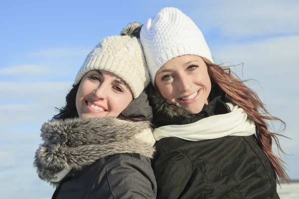 Two happy young girls having fun in winter park — Stock Photo, Image