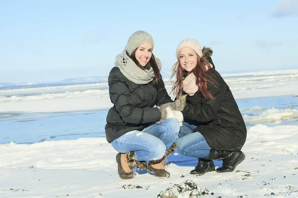 Two happy young girls having fun in winter park — Stock Photo, Image