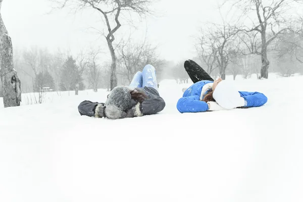 Two happy young girls having fun in winter park — Stock Photo, Image