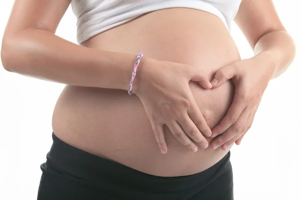 Foto van een zwangere vrouw over studio witte achtergrond — Stockfoto