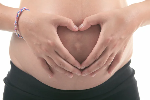 Foto di una donna incinta su sfondo bianco studio — Foto Stock