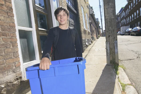 A teenager boy with recycle bin outside — Stock Photo, Image