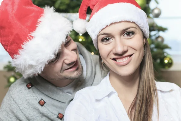 A Christmas Couple wearing Santas Hats. Smiling Family Celebrat Stock Picture