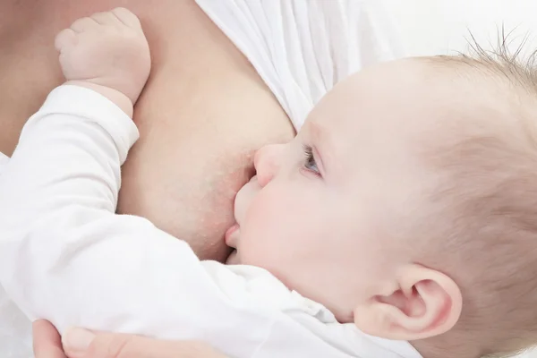 Baby feeds on mothers breasts milk — Stock Photo, Image
