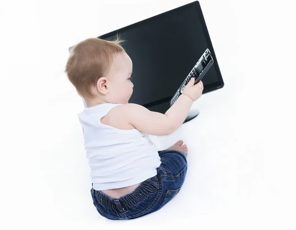 Studio portrait of a baby boy holding a tv remote — Stock Photo, Image