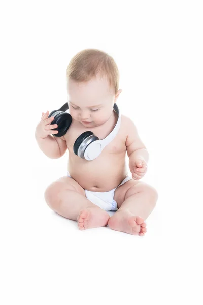 A young baby is sitting on a white isolated background listening — Stock Photo, Image