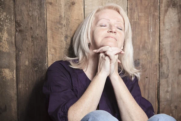 A senior person pray with a wood background — Stock Photo, Image