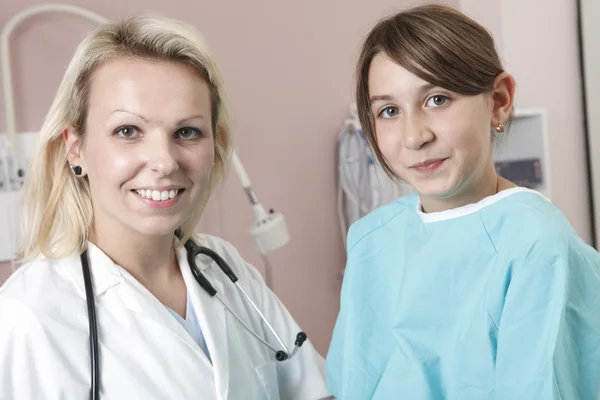 Happy little girl at the doctor for a checkup - being examined w — Stock Photo, Image