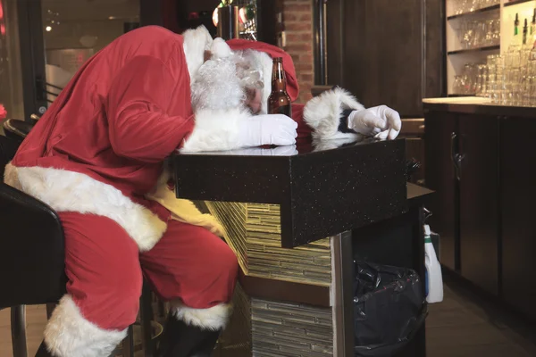 Un Santa Claus duerme en el bar. Demasiado borracho . — Foto de Stock