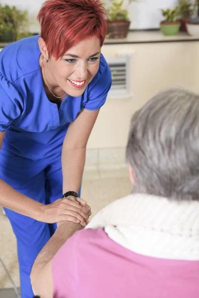Elderly lady with her physiotherapists in a hospital — Stock Photo, Image