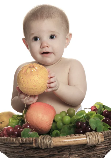 Happy little baby girl with fruits on the basket — Stock Photo, Image