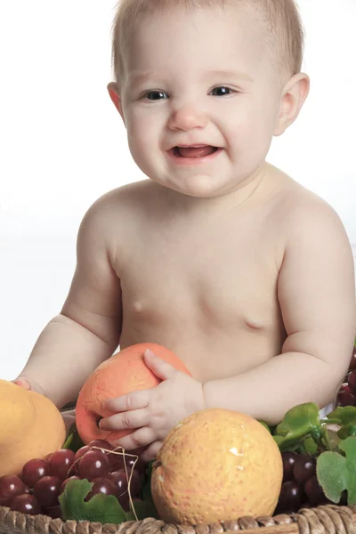 Happy little baby girl with fruits on the basket — Stock Photo, Image