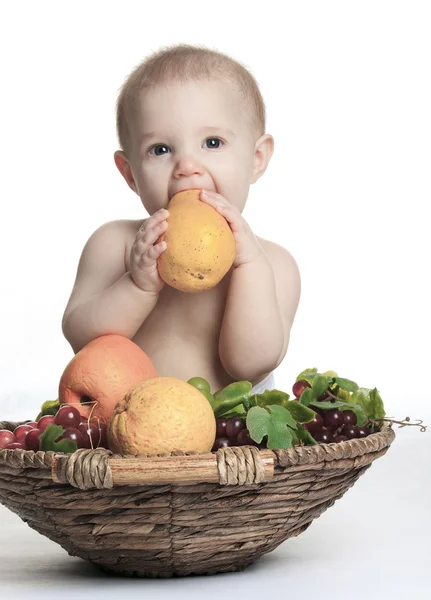 Happy little baby girl with fruits on the basket — Stock Photo, Image
