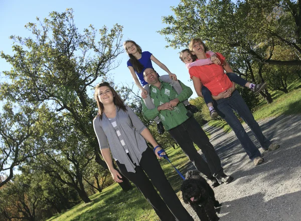 Family throw autumnal leaves — Stock Photo, Image