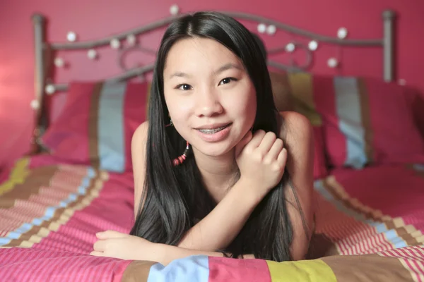 A Asian American teen lay on his bedroom — Stock Photo, Image