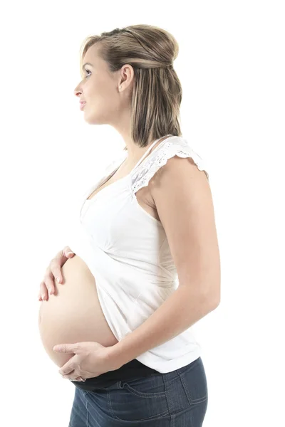 Young pregnant woman against white background — Stock Photo, Image