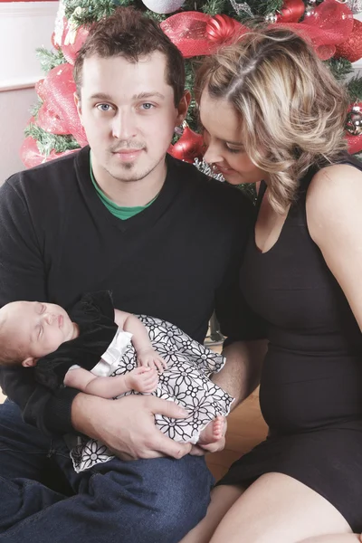 Un niño de Navidad con su madre delante de un abeto . — Foto de Stock