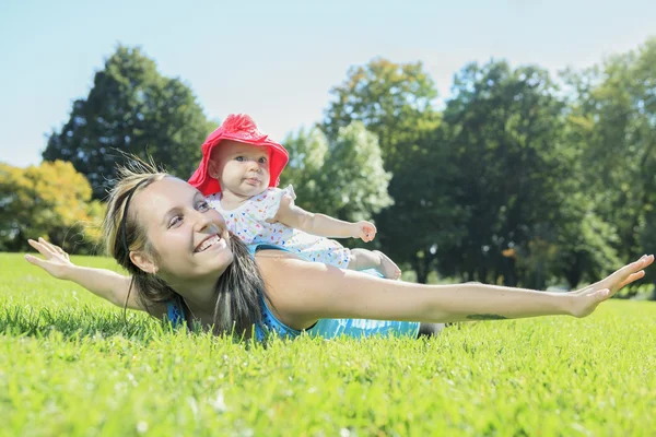 A mother training with baby on a summer day — Stock Photo, Image