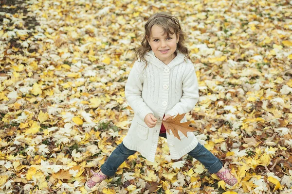 Little girl with autumn leaf — Stock Photo, Image