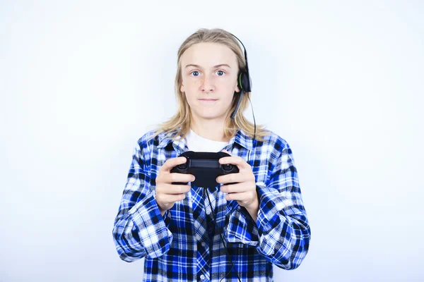 A teen boy playing video games against gray background — Stock Photo, Image