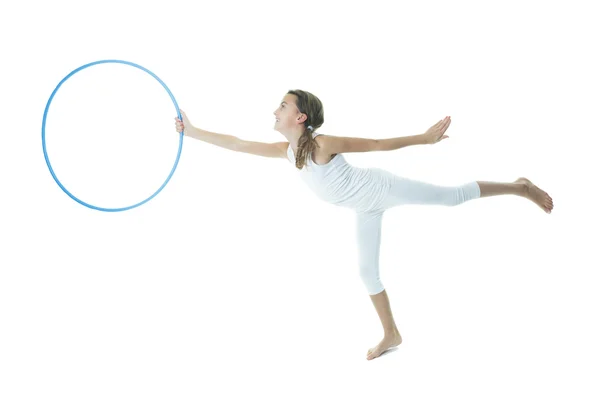 Little girl gymnast does exercise on studio white — Stock Photo, Image