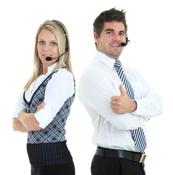 Young employee working with a headset and accompanied by his team — Stock Photo, Image