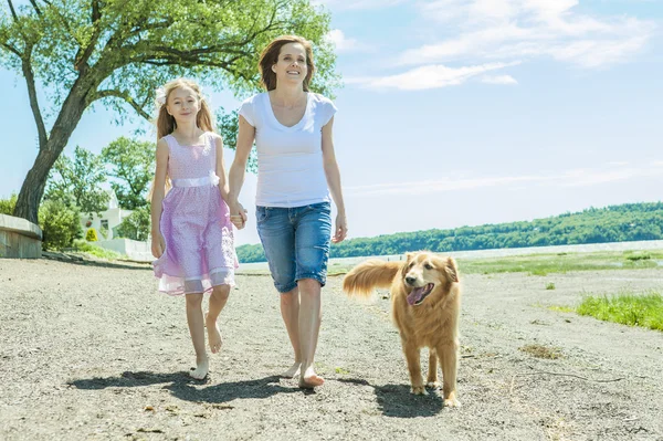 Glückliche Familie, die tagsüber am Strand spielt. — Stockfoto