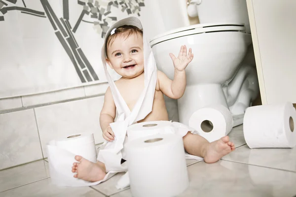 Toddler ripping up toilet paper in bathroom — Stock Photo, Image