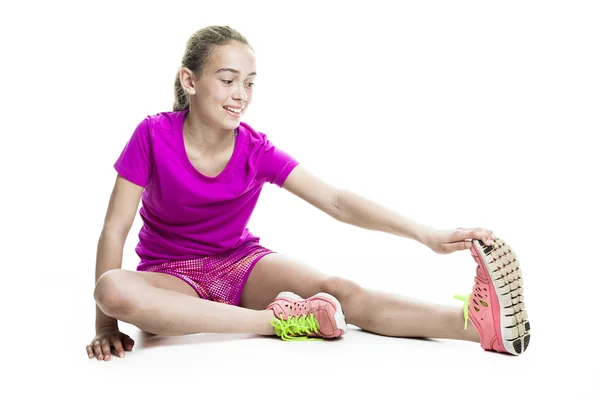 Running young girl in sport cothes, white background — Stock Photo, Image