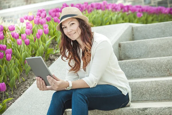 Urban woman sitting with tablet computer on stairs — Stock Photo, Image