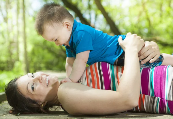 Beautiful mother and little baby boy in forest — Stock Photo, Image