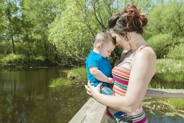 Beautiful mother and little baby boy in forest — Stock Photo, Image