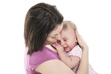 Mother trying to calm her crying baby clipart