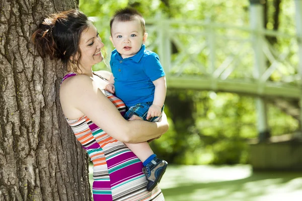 Beautiful mother and little baby boy in forest — Stock Photo, Image