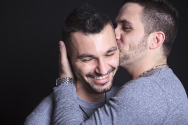 Gay couple on black background clipart
