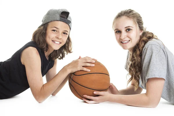 Portrait of brother and sister with a basket ball — Stock fotografie