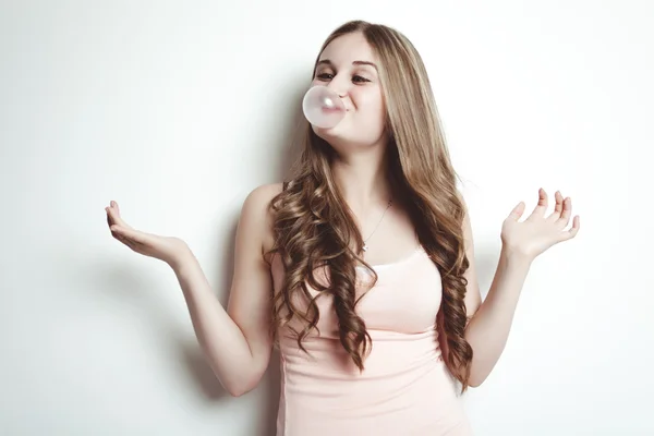 Blond teenager girl blowing a bubble gum balloon — Stok fotoğraf