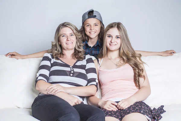 Affectionate mother son daughter sitting on sofa — Stockfoto