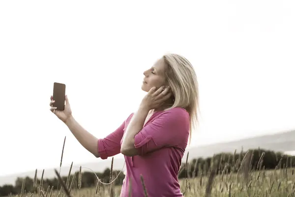 Photo of pretty blonde woman on a field — Stock Photo, Image