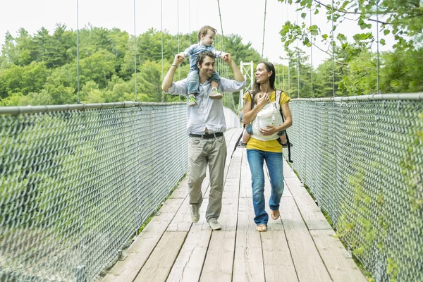 Family having fun on a small bridge — Stock Photo, Image